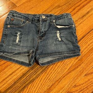 Blue jean shorts with 2 rips on each side which is on purpose 2 back pockets